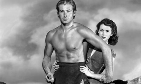 A bare-chested Tarzan holds a knife while Jane, standing behind him, hold onto him