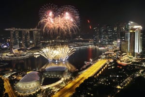 Fireworks explode above Singapore’s financial district at the stroke of midnight