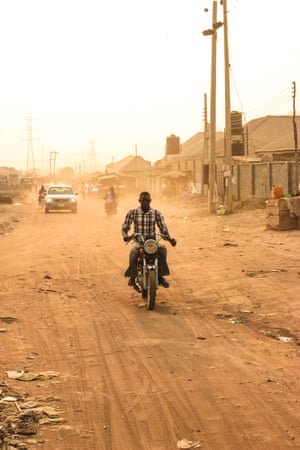 Abuja, Nigeria. Man without a helmet on a motorbike on a dirt road.
In Nigeria’s capital – and one of the fastest-growing cities in the world – getting to work for this man means negotiating questionable road surfaces.