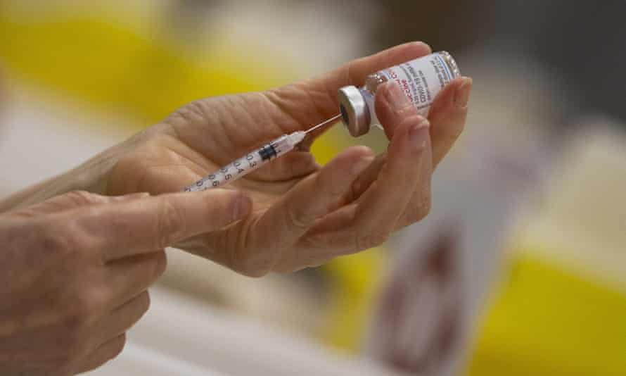 A health worker prepares a dose of Moderna Covid-19 vaccine