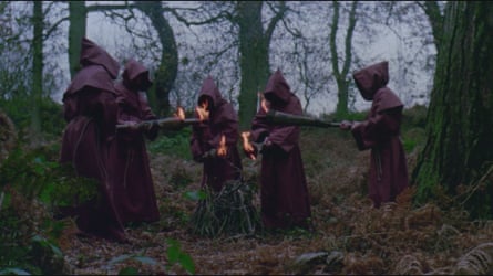 Hooded men with flaming torches in The Last Sacrifice.