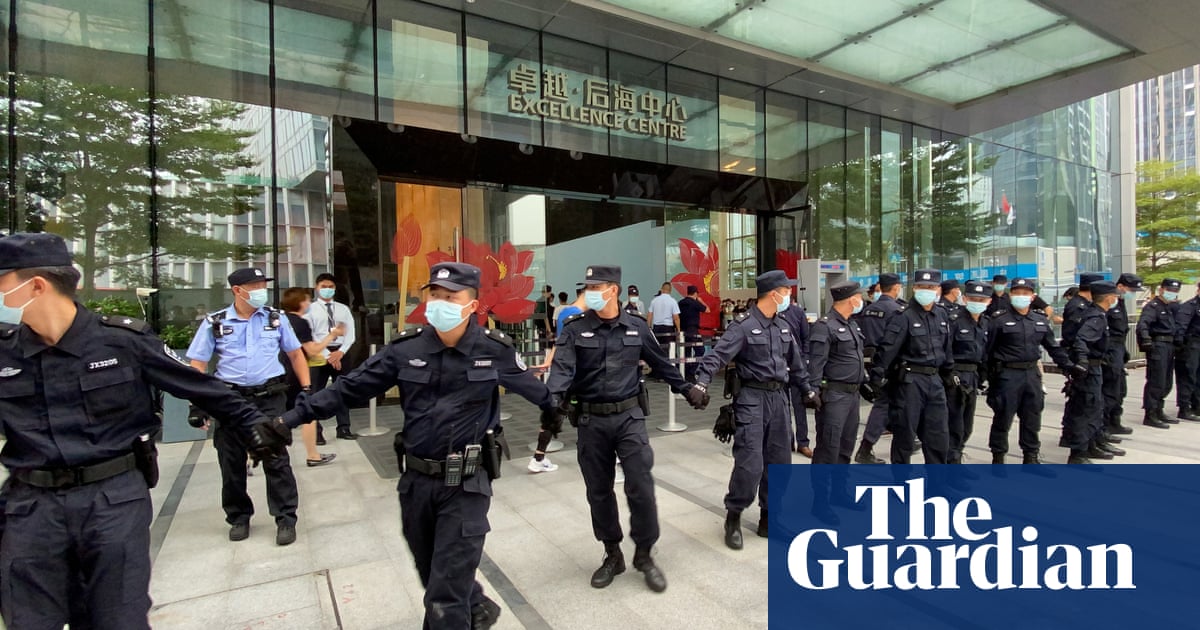 China property giant Evergrande admits debt crisis as protesters besiege HQ