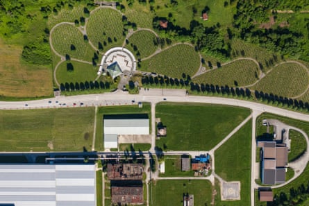A bird’s eye view shot shows the centre and thousands of graves among manicured greenery.