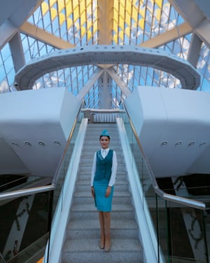 A tour guide on the steps leading to the ceremonial meeting room at the summit of the Palace of Peace and Reconciliation, designed by Foster + Partners as a global centre for religious understanding.