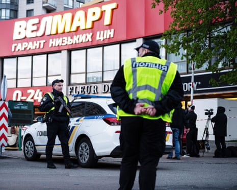 Police standing outside a supermarket.