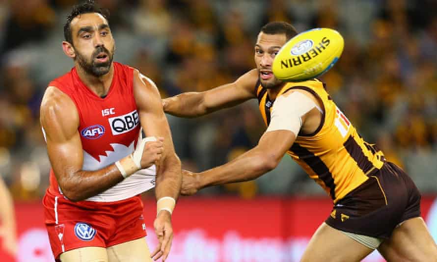 Adam Goodes (left) in action for Sydney Swans in a match against Hawthorn in May 2015, his final season in the AFL.