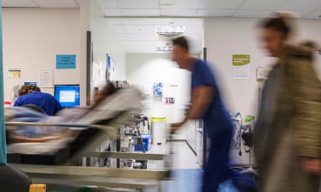 A patient is wheeled down a hospital corridor