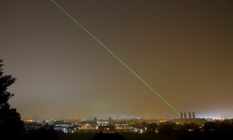 Laser being projected from the Royal Observatory at Greenwich across the London skyline marking the Prime Meridian line.