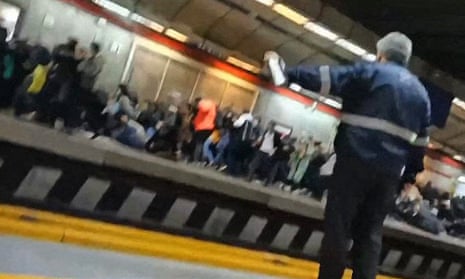 A video shows people fleeing the metro station and falling down as gunshots are heard. 