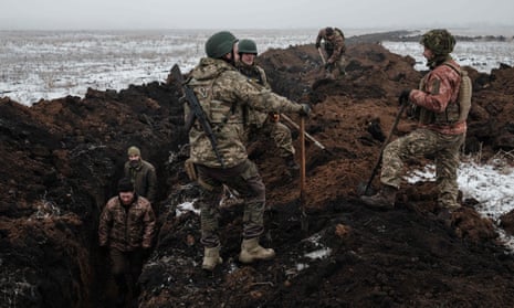 Ukrainian servicemen dig a trench near Bakhmut.