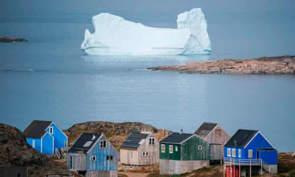 Icebergs float behind the town of Kulusuk in Greenland
