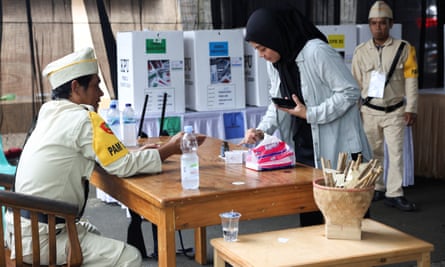 A woman has ink applied to her finger to show she has voted in South Tangerang, on the outskirts of Jakarta