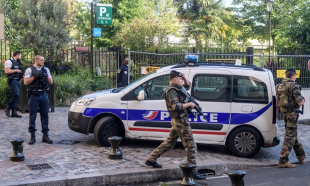 Police and military officers set up a security perimeter near the site of the incident in Levallois-Perret, Paris