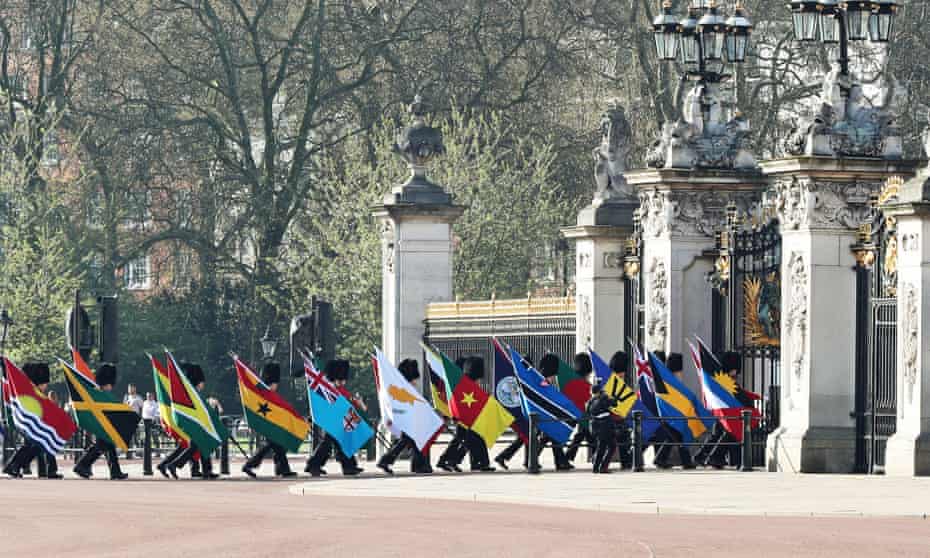 A guard of honour carrying the 53 Commonwealth flags arrives at Buckingham Palace ahead of the formal opening of the Commonwealth heads of government meeting. 