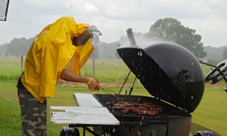 Man barbecuing in the rain