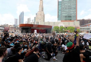 Demonstrators take a knee during a protest against racial inequality in Brooklyn