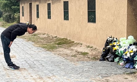 A man bows in front of the former house of Li Keqiang in Dingyuan county, Chuzhou city, in China’s eastern Anhui province.