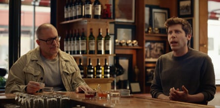 Two men sit in a cafe