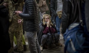A woman reacts as she waits for a train trying to leave Kyiv, Ukraine, on Thursday.