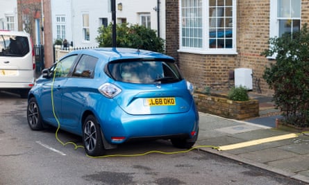 Renault Zoe being charged using an electrical cable from a house.