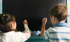 Children writing on a blackboard