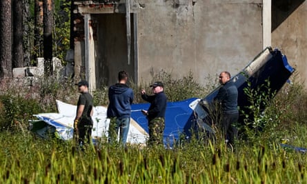 Investigators in front of the downed jet