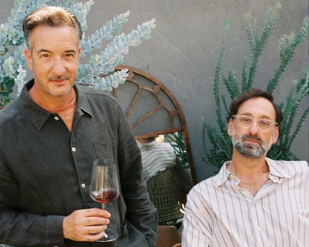 Two middle-aged men drinking wine