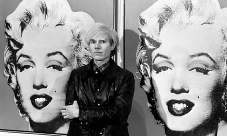 Andy Warhol stands in front of his double portrait of Marilyn Monroe at the Tate Gallery in London.