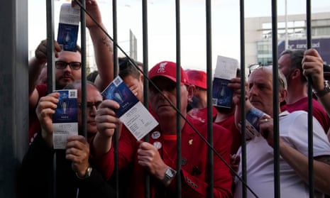 Liverpool fans show their tickets in front of the Stade de France in Paris prior the Champions League final