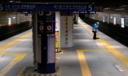 A worker cleans up the platform at Ginza subway station in Tokyo