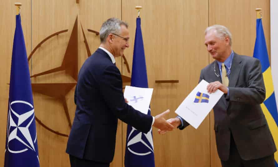 Jens Stoltenberg (left) shakes hands with Sweden’s ambassador to Nato, Axel Wernhoff, in Brussels