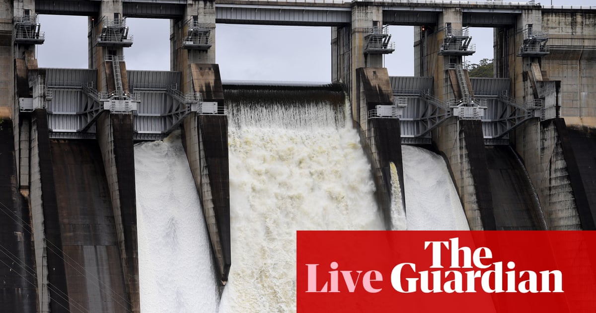 Australia news updates live: Warragamba Dam spills as NSW braces for more flood damage; second Lismore death; M1 drivers still stranded