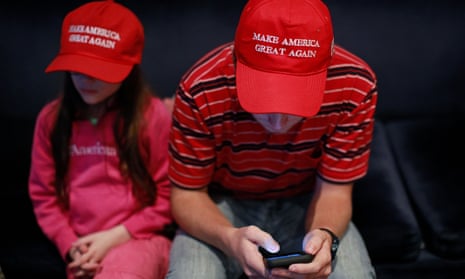 A supporter checks his phone at a rally for Republican Mike Braun in Indiana.