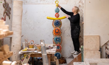 Ceramic artist Sandy Brown working on a scale model of Earth Goddess in her studio in Appledore.