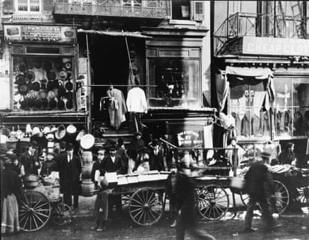 Shoppers congregate as vendors sell their wares on the sidewalk outside haberdasheries