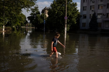 A child wades through rising flood water in central Kherson around 300 metres from the Dnipro river.