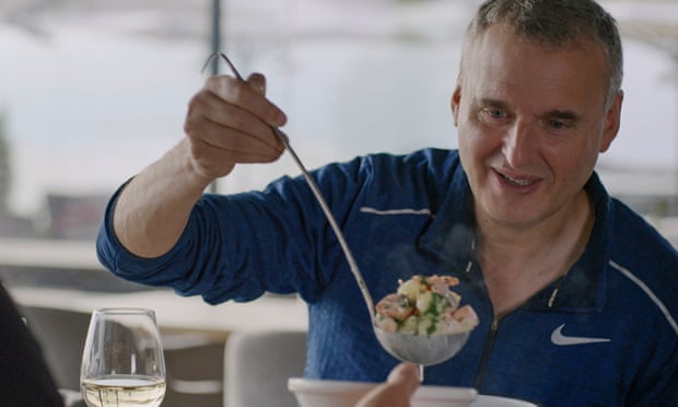 Phil Rosenthal looking hungrily at a ladleful of food in in Somebody Feed Phil.