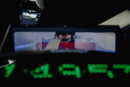 view of hasan’s hands at desk, with green lit-up numbers in the foreground