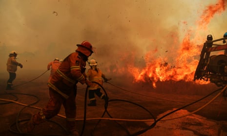 The death toll from bushfires in NSW and Queensland has risen to four. Firefighters battle a spot fire at Hillville, New South Wales.