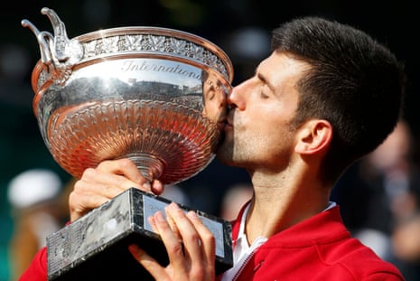 Novak Djokovic kisses the trophy.