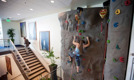 Google employee using workplace climbing wall