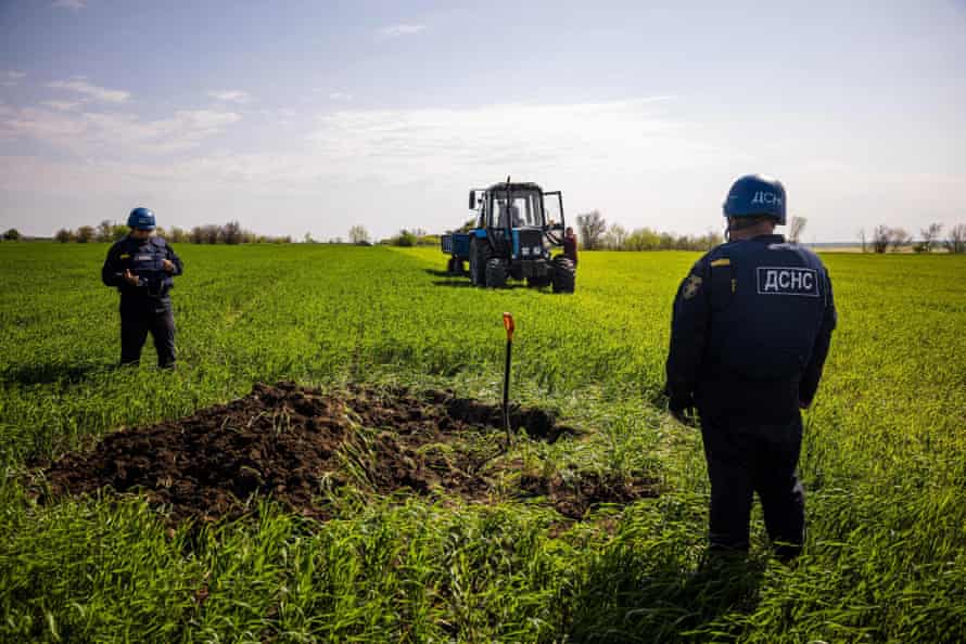 Members of a demining team of the State Emergency Service of Ukraine prepare to destroy an unexploded missile near the village of Hryhorivka, Zaporizhzhia region.