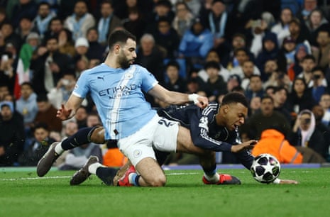 Manchester City's Rayan Ait-Nouri tackles Real Madrid's Kylian Mbappe.