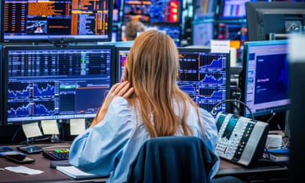 Female trader sitting at screens