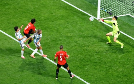 Egypt's keeper Mostafa Shoubir saves a header from Argentina's Alexis Mac Allister.
