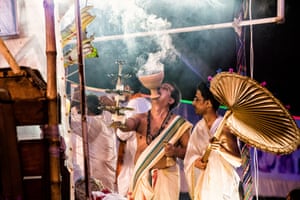 The famous Dhunuchi Naach (a dance with an earthen incense burner) being performed by a priest on one of the floats on the Immersion Carnival. He has a clarified butter lamp in one hand and a brass bell in the other.
