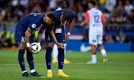 Neymar and Kylian Mbappé speak before a penalty kick during PSG’s game against Montpellier.