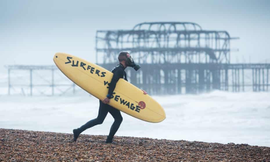 A member of Surfers Against Sewage on Brighton Beach – the environmental charity highlights the sewage discharge into coastal and inland waters by UK water companies.