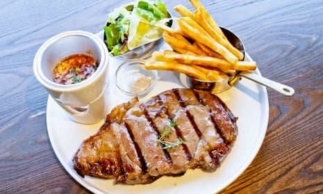 Rib-eye steak with salad and fries.