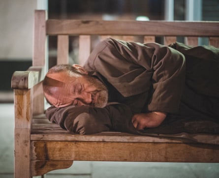 A man sleeps on a bench